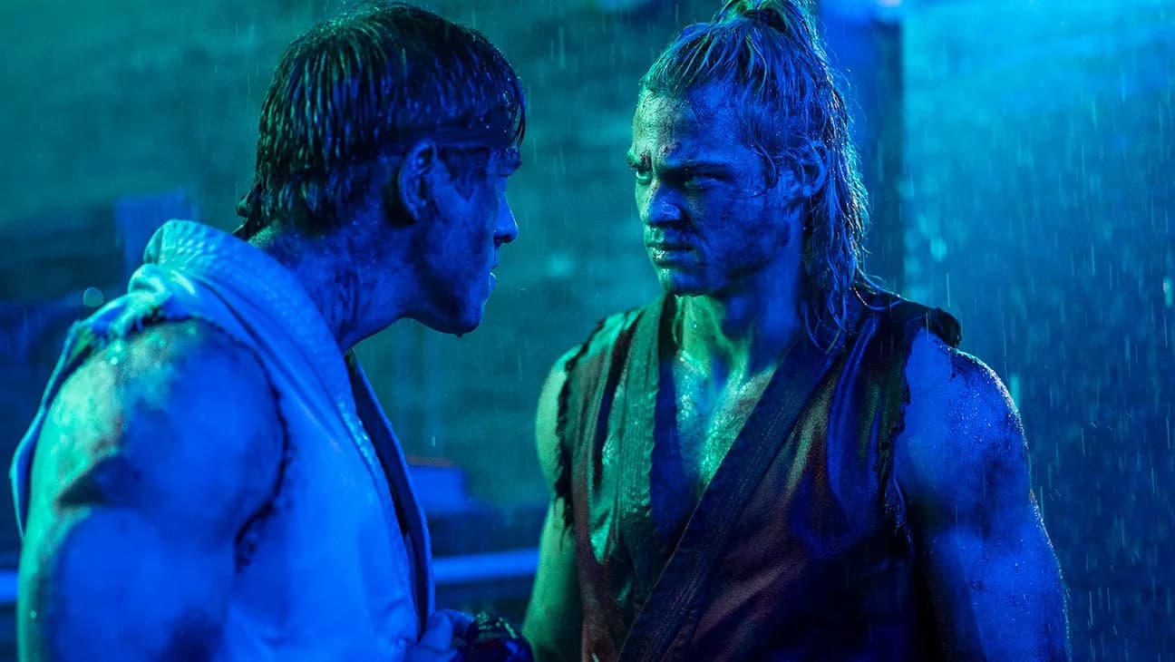 A still from the Street Fighter movie showing Noah Centineo in a combat stance, surrounded by blurred action shots.