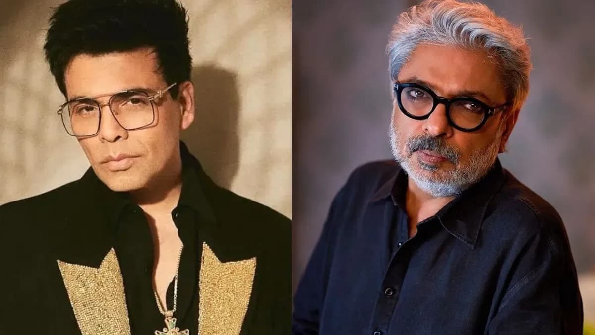 Karan Johar and Sanjay Leela Bhansali standing side by side at a film event, both wearing formal attire.