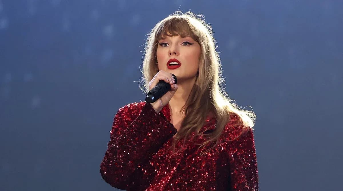Taylor Swift performing on stage at a red carpet event