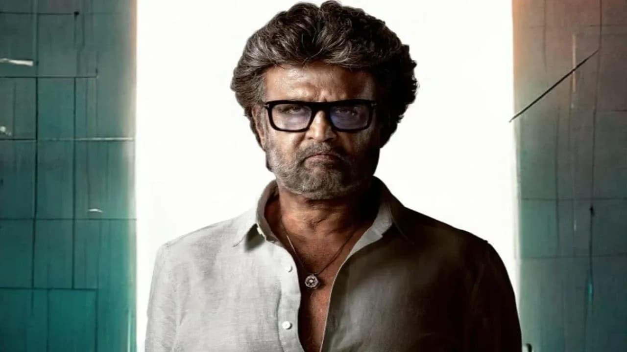 Rajinikanth in Jailer, standing in front of a prison gate, silhouette against a grey sky