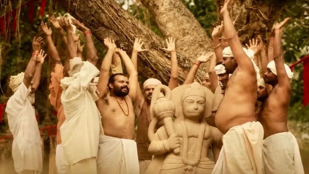 A still from Hanuman Ansh showing the deity in a temple setting, glowing light around him