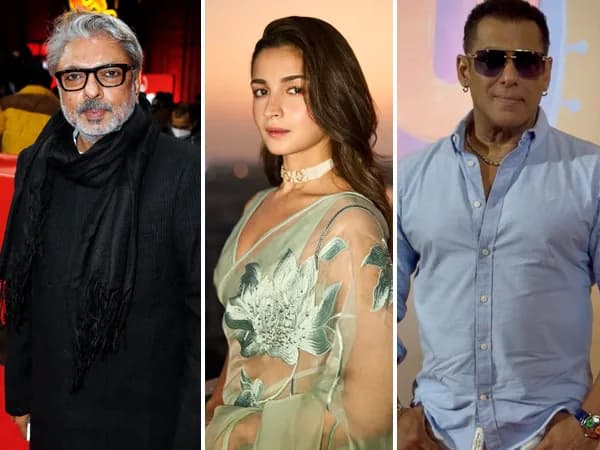 Alia Bhatt and Sanjay Leela Bhansali standing together at a film event, looking serious.