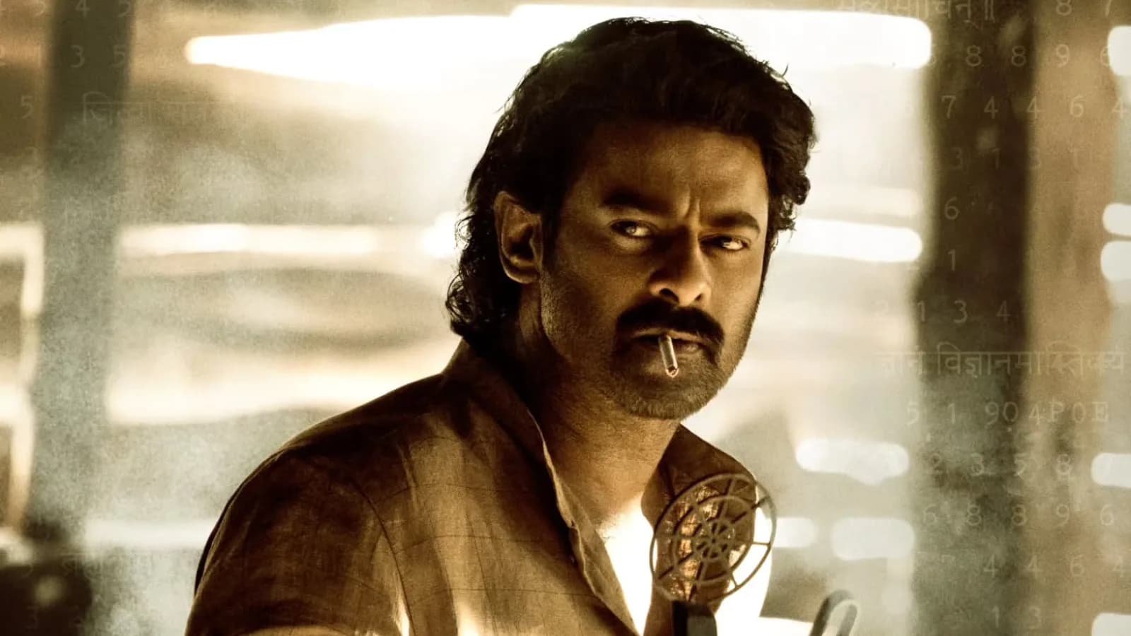 Prabhas in rugged period look from Fauji birthday glimpse holding cigarette with Netaji portrait in background